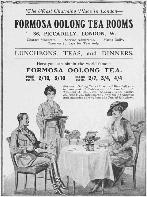Ad. A black and white picture below shows a man in military uniform and a woman wearing a long gown and hat sitting at a table. A woman wearing a kimono stands holding a tea tray near the man. Text above begins, “The Most Charming Place in London— Formosa Oolong Tea Rooms 36, Piccadilly, London, W”.