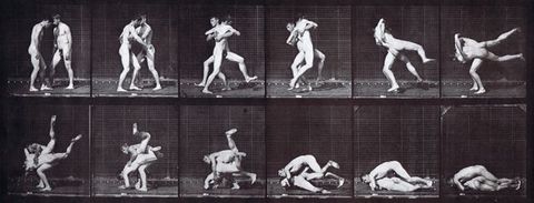 Black and white photographs. Two nude, pale-skinned men wrestle. Two rows of six frames each show different instants in their action in consecutive order across all twelve shots.
